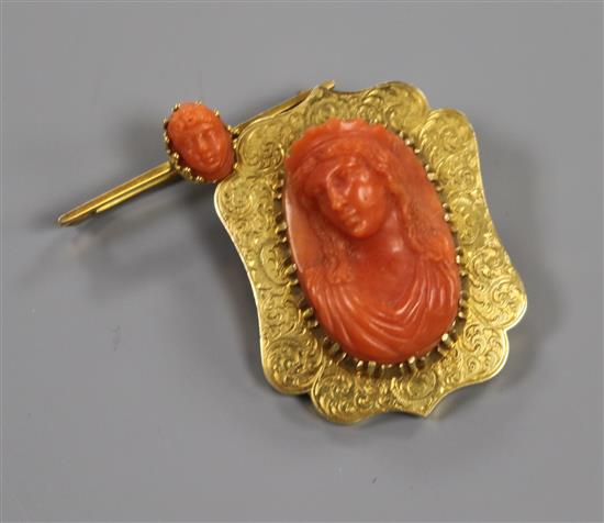 An engraved yellow metal and carved coral bust brooch and another similar bar brooch, 40mm.